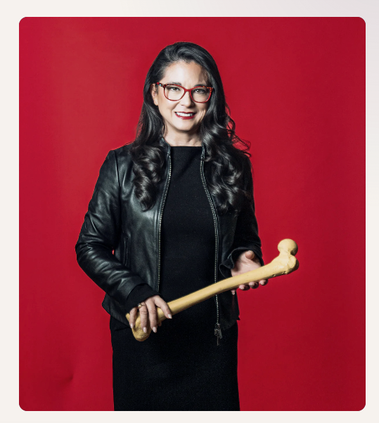 Dr. Vonda Wright holding a femur bone